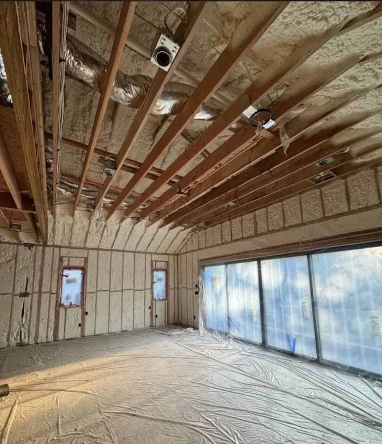 Interior walls and ceiling insulated with spray foam during new construction in East Rutherford